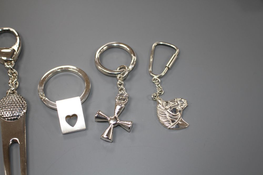 Seven assorted modern silver keyrings including novelty pig and horses head,